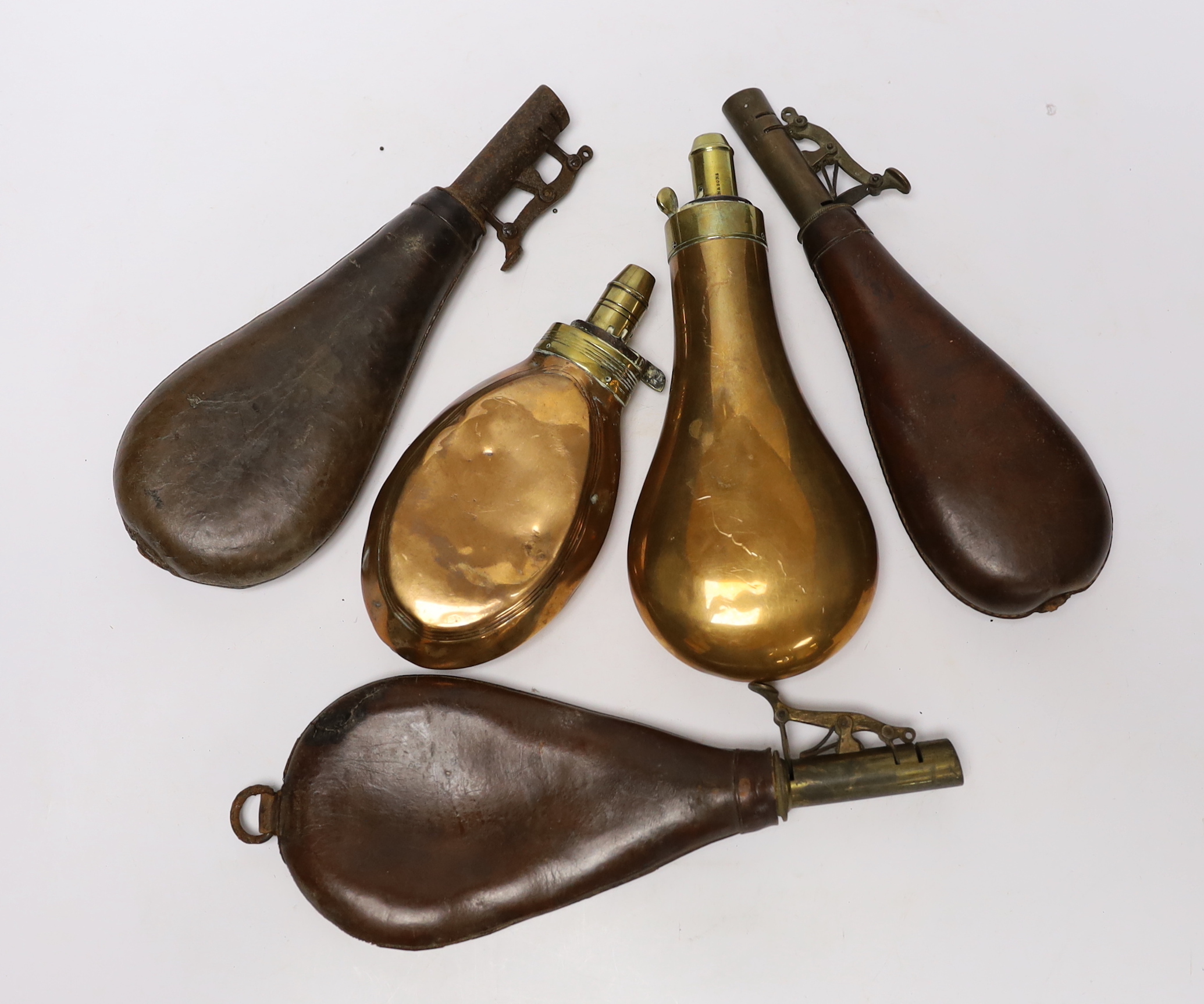 Five powder flasks; two with copper pouches and three with leather pouches